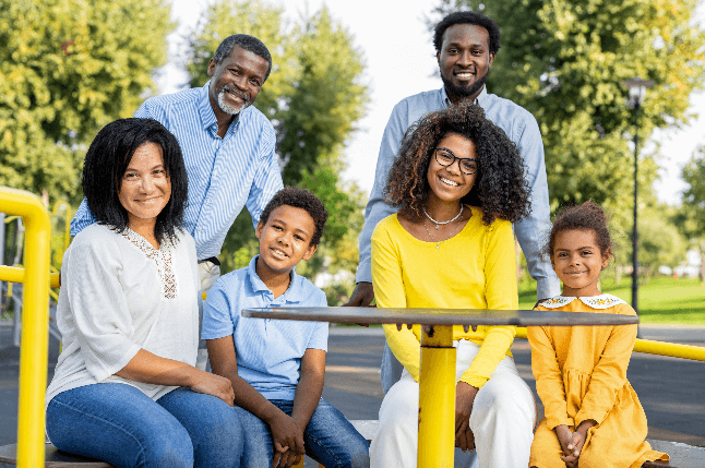 A multigenerational family enjoying quality time together at a park, embodying the values and aspirations detailed in a letter of intent.