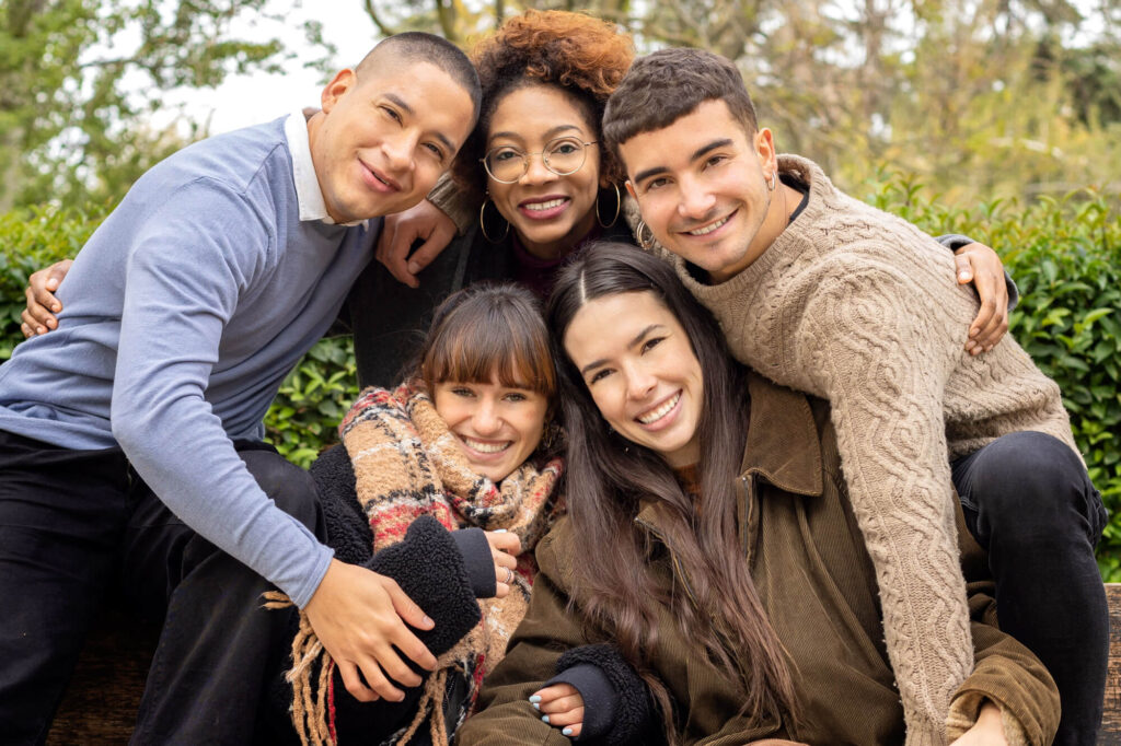 A close-knit group of five diverse friends share a joyful moment outdoors, embodying the supportive spirit of special needs trusts.